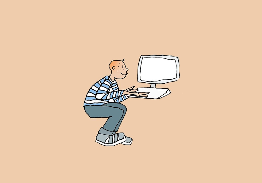 Boy sits in front of his computer
